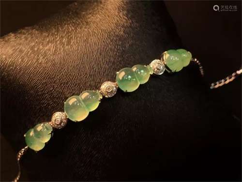 A Chinese Carved Jadeite Bracelet