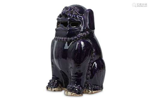 A CHINESE AUBERGINE-GLAZED LION DOG.