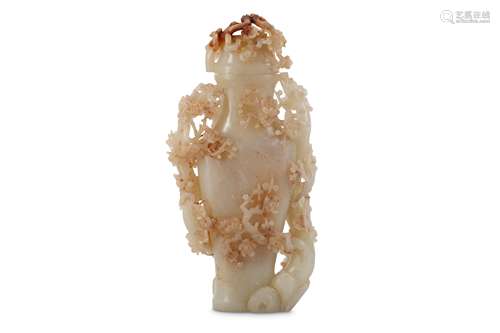 A CHINESE PALE CELADON JADE ‘PRUNUS’ VASE AND COVER.