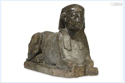 AN EGYPTIAN SERPENTINE SPHINX