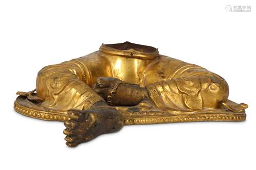 A TIBETAN GILT-BRONZE FRAGMENT OF A BUDDHIST SCULPTURE.