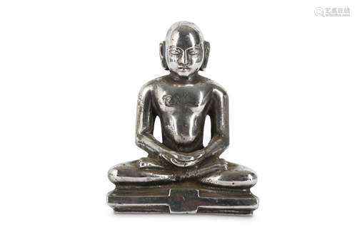 A WHITE METAL BUDDHIST FIGURE.