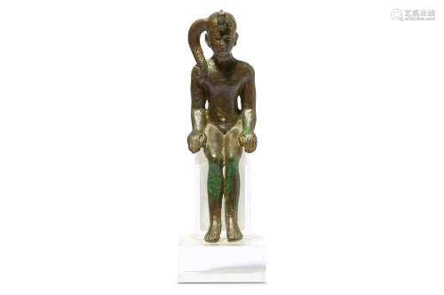 AN EGYPTIAN SEATED FIGURE OF CHILD HORUS
