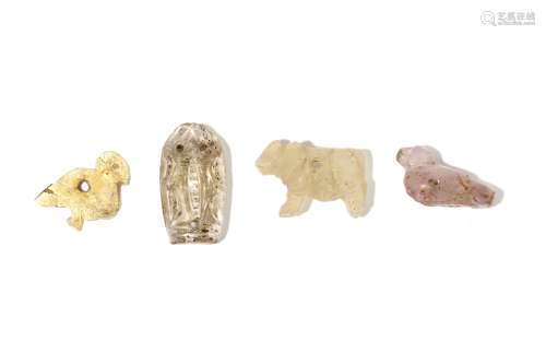 FOUR NEAR EASTERN HARDSTONE AND SHELL AMULETS