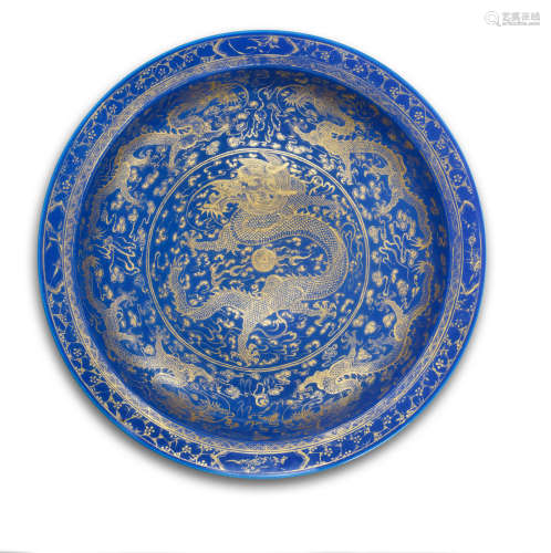 Qianlong six-character mark, Guangxu A large gilt-decorated powder-blue glazed dish