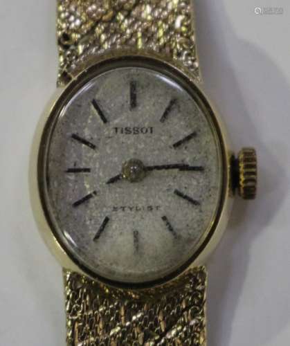 A Tissot Stylist 9ct gold lady's bracelet wristwatch, the signed oval silvered dial with black