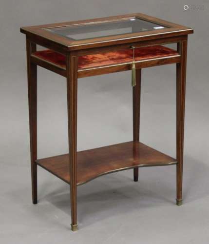 An Edwardian brass mounted rosewood bijouterie table, the hinged lid with bevelled glass, raised