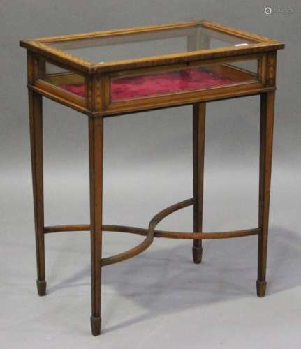 An Edwardian satinwood bijouterie table, the glazed top with foliate inlaid scrolls, raised on