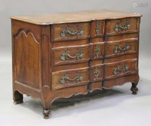An 18th century French fruitwood serpentine fronted commode chest of two short and two long drawers,