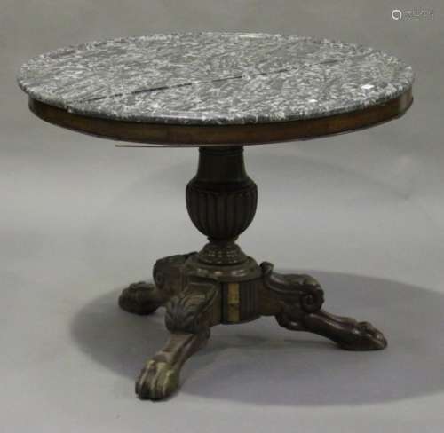 A late 19th/early 20th century French mahogany circular centre table with grey marble top, raised on