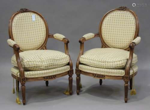 A pair of late 20th century Louis XV style stained beech fauteuil armchairs with carved