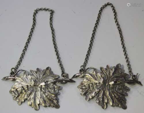A pair of William IV silver decanter labels, each in the form of a vine leaf, pierced with '