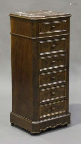 An early 20th century French walnut narrow bedside chest of drawers, the rouge marble top above a