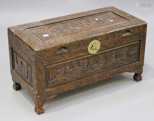 A 20th century South-east Asian softwood trunk with overall carved decoration, on block feet, height