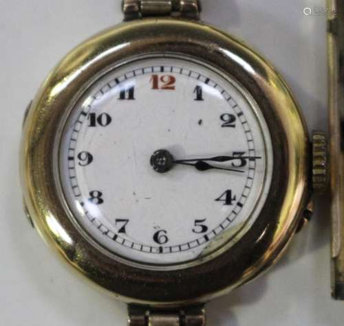 A 9ct gold circular cased lady's wristwatch with unsigned jewelled movement, the enamel dial with