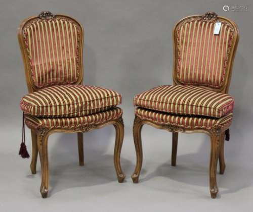 A pair of late 20th century Louis XV style stained beech salon chairs with carved decoration,