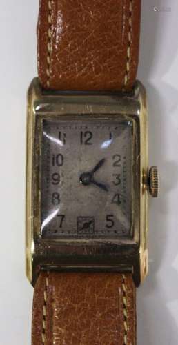 A 9ct gold rectangular cased gentleman's wristwatch with jewelled movement, the silvered dial with