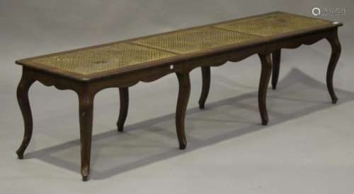 A 20th century French walnut and caned window seat, raised on cabriole legs, height 47cm, length