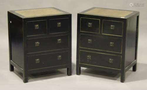 A pair of modern South-east Asian ebonized bedside chests of two short and two long drawers, the