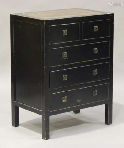 A modern South-east Asian ebonized chest of two short and three long drawers, the top inset with