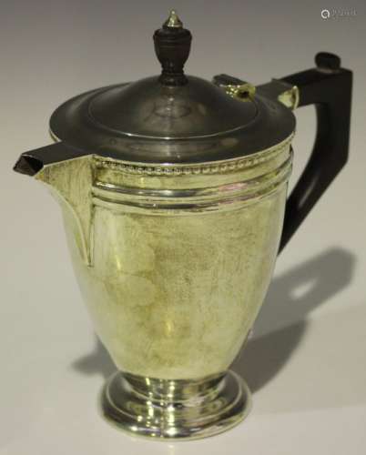 A George V silver hot water jug with beaded border, Birmingham 1929 by Barker Brothers Silver Ltd,