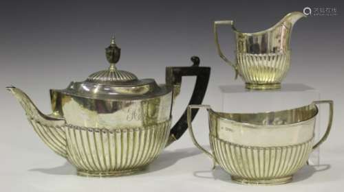 A silver matched three-piece tea set of half-reeded form, comprising teapot, London 1899 by