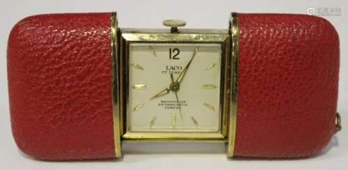 A Laco gilt metal and red leather cased purse watch, the square silvered dial with gilt '12',