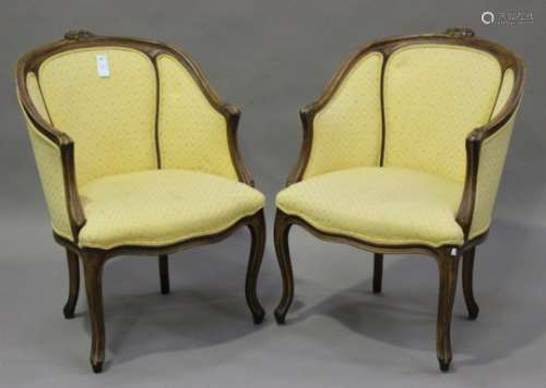 A pair of late 20th century Louis XV style stained beech framed tub back armchairs with carved
