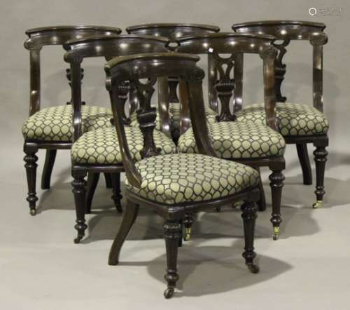 A set of six late Victorian walnut dining chairs, the incised and carved backs above overstuffed