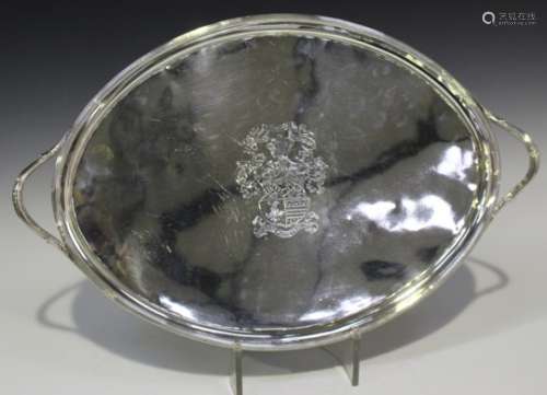 A George III silver two-handled oval tea tray, the centre engraved with a shield crest within a