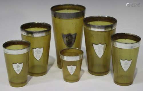 A matched set of six late Victorian and later silver mounted interfitting horn beakers, each mounted