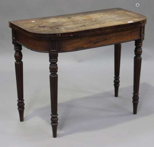 William IV rosewood fold-over card table, the hinged top raised on turned and reeded legs, height