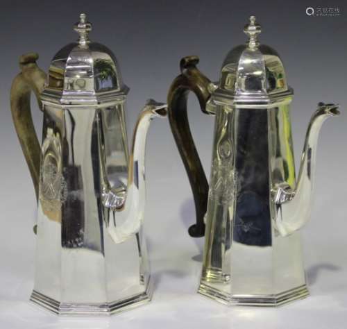A pair of Elizabeth II Britannia silver hot water jugs, each of tapering octagonal form with domed