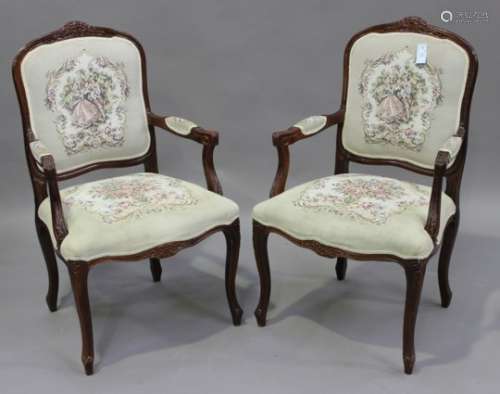A pair of late 20th century stained beech fauteuil armchairs with carved decoration, upholstered