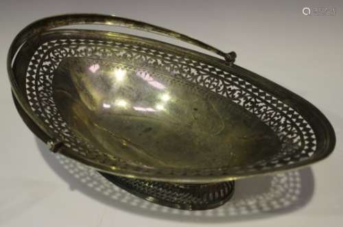 A George III silver oval bread basket with pierced and engraved foliate borders and reeded rim,