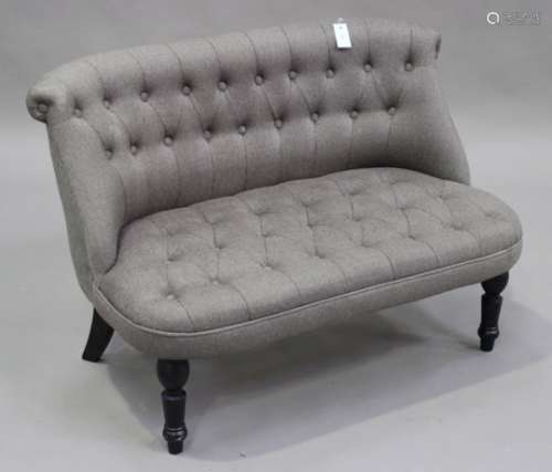 A modern two-seat settee, upholstered in grey fabric, on turned ebonized legs, height 74cm, length