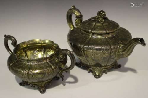 An early Victorian silver teapot, decorated with foliate scrolls, the hinged lid with flowerbud