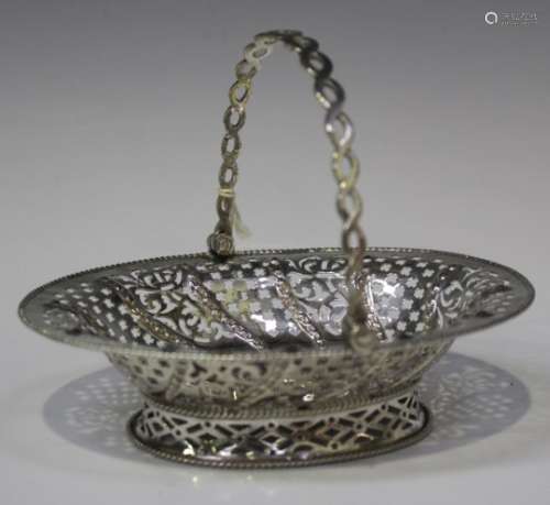 A George III silver oval bonbon basket, the entwined swing handle above pierced and beaded sides