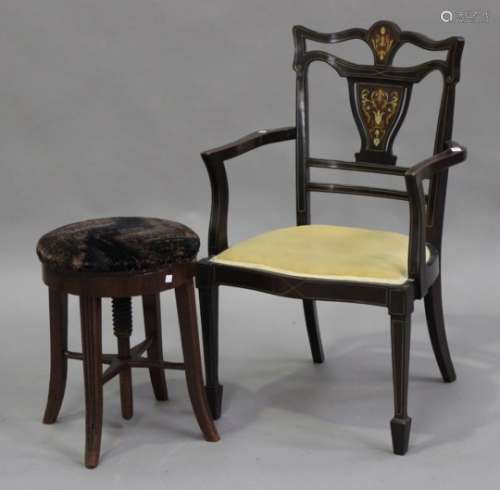 An Edwardian walnut and foliate inlaid open armchair, the overstuffed seat raised on square tapering