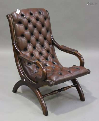A late 20th century reproduction mahogany framed armchair, with buttoned brown leather seat and