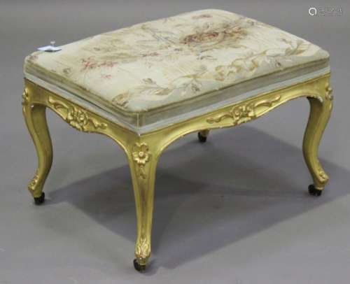 A mid-Victorian century giltwood rectangular stool, the period needlework seat raised on carved