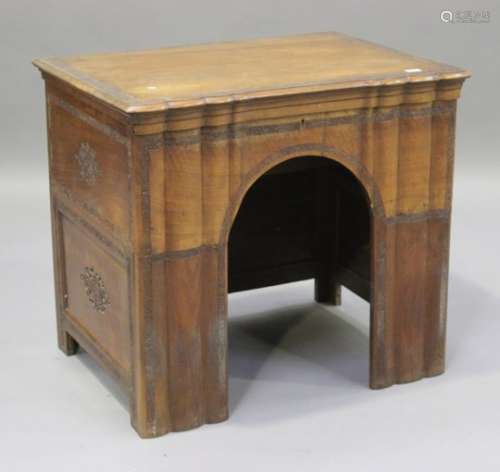 An early 20th century Kashmiri walnut writing desk, finely carved with foliate borders and reserves,