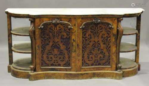 A Victorian walnut credenza with white marble top, the serpentine front above a pair of fretwork