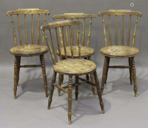 A set of four late 19th century beech stick back kitchen chairs, probably manufactured by Ibex,