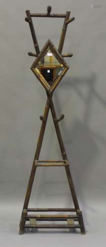 A Victorian bamboo hall stand, fitted with seven hooks and a mirror, height 198cm, width 59cm.