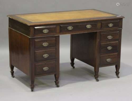A late Victorian walnut twin pedestal desk, the moulded top inset with a gilt-tooled brown leather