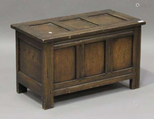 A 20th century oak panelled coffer, fitted with a hinged lid, height 44cm, width 76cm, depth 40cm.