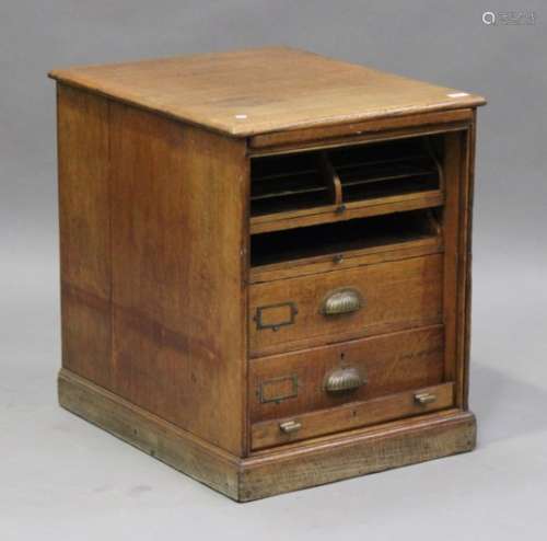 A George V oak tambour fronted filing cabinet, the interior fitted with two sliding trays and two