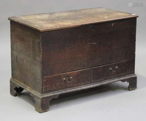 A late George III provincial oak blanket chest, the hinged lid above two drawers, on bracket feet,