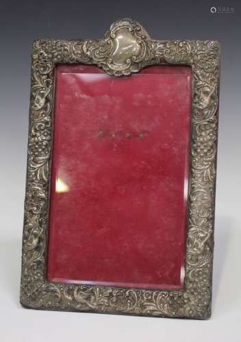 A late Victorian silver mounted rectangular photograph frame, pierced and embossed with birds